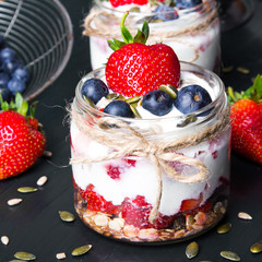 Wall Mural - delicious dessert - yogurt with strawberries and blueberries