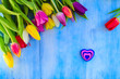 © Intel - Tulips with a heart on a blue table, top view