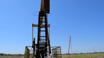 Wall Mural - The pumping unit on a well. Equipment of oil wells.