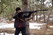 © AlexR - pretty country style woman in winter forest aim a shotgun