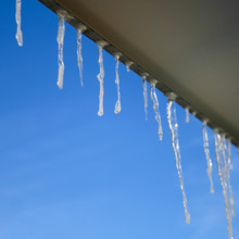 Beautiful Icicles Glint In The Sun Against The Blue Sky