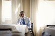 © Erickson Stock - Worried businessman sitting on his own in restaurant.