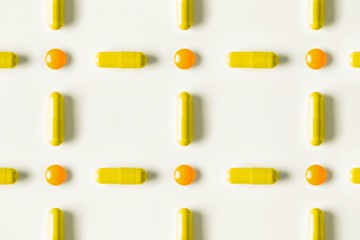 medical pills and capsules pattern on white background. flat lay, top view.