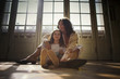 © Erickson Stock - View of a mother cuddling her daughter.
