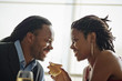 © Erickson Stock - Happy young couple gazing into each other's eyes as they enjoy a romantic dinner.