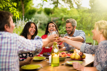 Poster - Group of friends toasting during a party on a terrace in summer