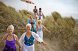 © Erickson Stock - Happy mature friends enjoying a day at the beach.