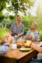 Wall Mural - Group of friends dinning on the terrace one summer evening