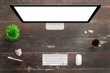 Poster - Computed display on wooden desk. Creative workplace for designer. Top view of table with green plant, coffee mug, usb, keyboard, mouse, paper and pen.