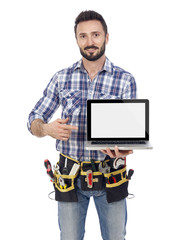 Canvas Print - Handyman pointing on laptop