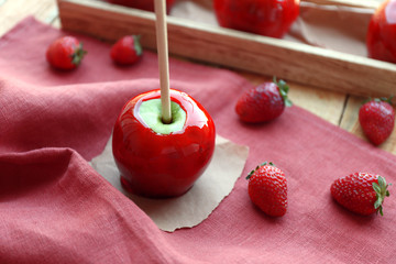 Sticker - Candy apple with strawberry on pink fabric closeup