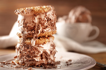 Sticker - Plate with delicious chocolate ice cream cookie sandwiches on wooden table