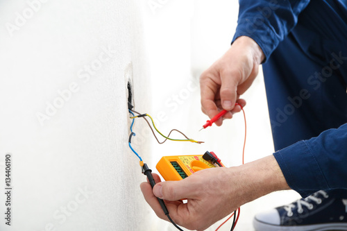Fotografía Electrician measuring earth resistance prior to installation of new socket, clos