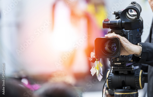 фотографія  Video camera operator working with his equipment