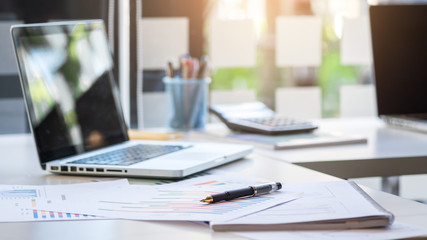 Business desk with a keyboard, report graph chart, pen and table