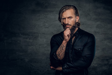 A man with tattooed arm wearing black shirt.