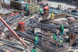 Laborers working on modern construction site works in Dubai. Fast urban development concept.