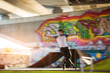 Young man is rollerblading. Rollerblader and graffiti. High speed and perfect balance.