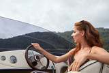 Fototapeta Tulipany - Summer vacation - young woman driving a motor boat