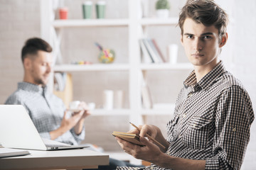 Poster - Handsome man writing in notepad