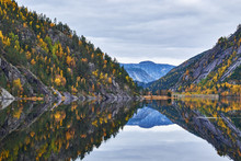 Completely Calm Waters On Lake Flaani, Between Mountain Sides Covered In Autumn Colored Trees, Near Route 9 In Southern Norway