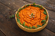 Appetizing pumpkin pie with mint on wood. Sweet homemade squash pastry on rustic wooden table. Confectionery, autumn meal, bakery concept