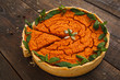 Pumpkin pie with cut piece closeup. Tasty orange squash cake decorated with mint leaves, ready for eating. Homemade bakery, traditional sweet, seasonal cuisine concept