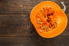 Cut Half Of Orange Pumpkin On Wood Free Space Flat Lay. Top View On Rustic Wooden Table With Cutaway Fresh Squash. Seasonal, Dieting, Vegetarian Cuisine Concept. Free Space For Your Text.