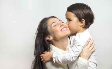 little girl kissing her mother