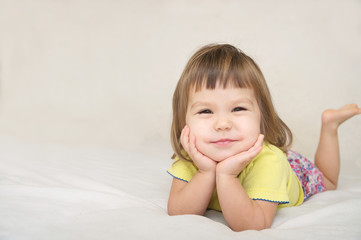 Wall Mural - smiling happy little girl portrait with cute cheeks isolated