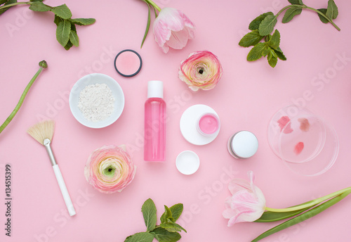 Natural cosmetic pink flat lay with flowers, Top view