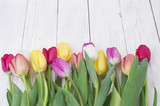 Fototapeta Tulipany - bouquet of tulips on rustic wooden board, easter decoration