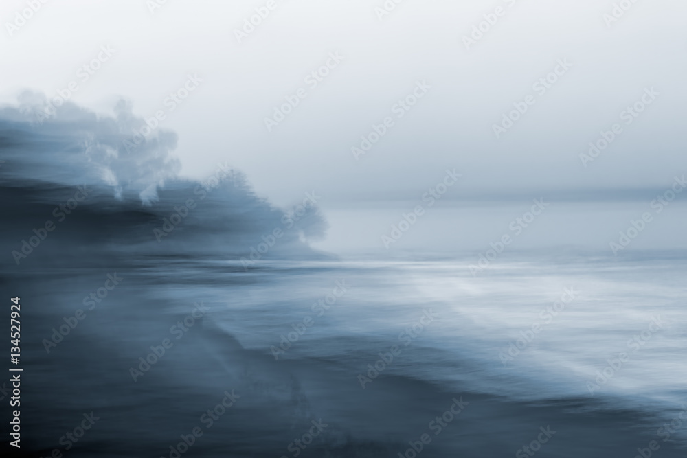 Motion Blurred Seascape. A monotone, blurred seascape made using a long exposure combined with horizontal panning motion. - obrazy, fototapety, plakaty 