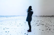 © abelhalasz - Motion blurred woman walking alone on a dreary agricultural land at winter. Goodbye concept