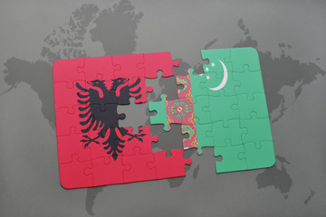 puzzle with the national flag of albania and turkmenistan on a world map