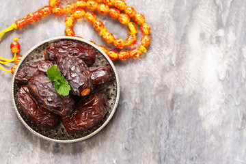 Sweet dried figs dates in a plate on the table