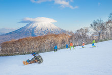 People Skiing On The Snow Slope And Mt.Yotei As A Background In Niseko Ski Area, Hokkaido, Japan