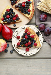 Wall Mural - Piece of fruit tart with blackberries, raspberries and blueberri