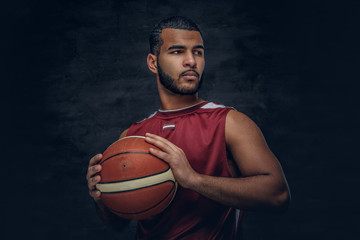 Wall Mural - A black man holds a basket ball.