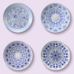 Set of decorative porcelain dishes with blue ethnic pattern in the style of Chinese painting on porcelain
