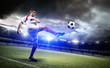 © efks - Football player is kicking a ball in the stadium.