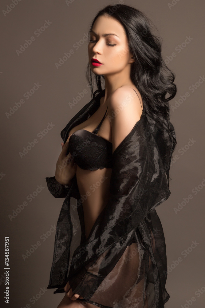 sexy brunette in black lingerie front view of attractive sexy brunette girl in black bra looking at camera  isolated on white Stock Photo by LightFieldStudios