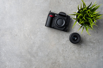 Modern camera on gray stone table