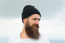 Bearded Handsome Smiling Man In Hat On Cloudy Sky