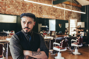 Wall Mural - Stylish hairdresser standing at his shop