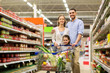 © Syda Productions - family with food in shopping cart at grocery store