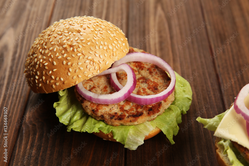 Tasty burger on wooden table