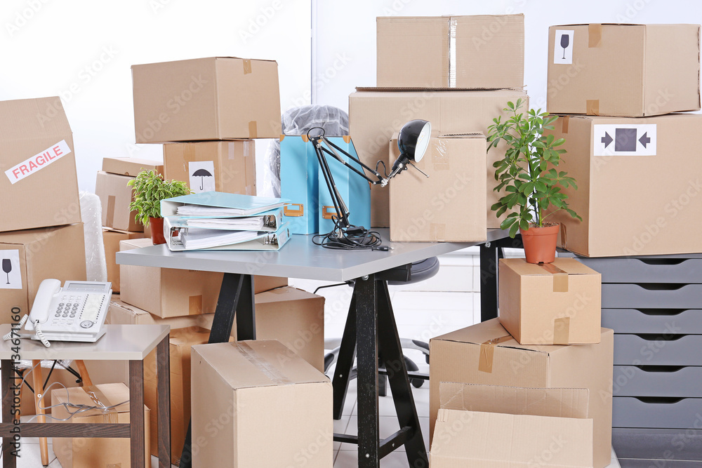Move concept. Unpacking cardboard boxes in a new office Stock Photo ...