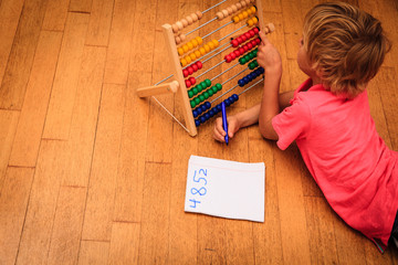 Wall Mural - little boy learning numbers and play with abacus