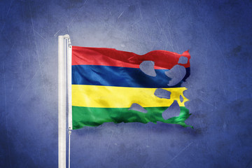 Wall Mural - Torn flag of Mauritius flying against grunge background